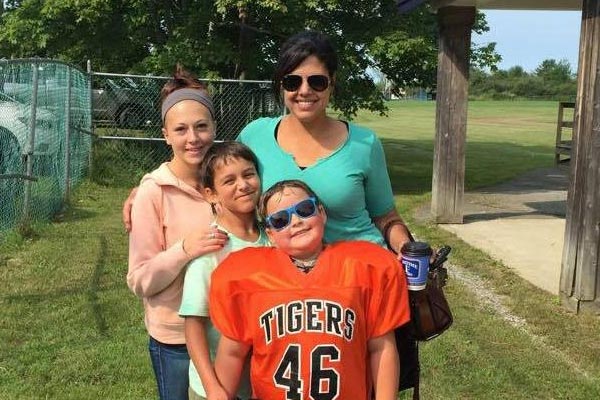 Photo of Emily and her kids at a football game