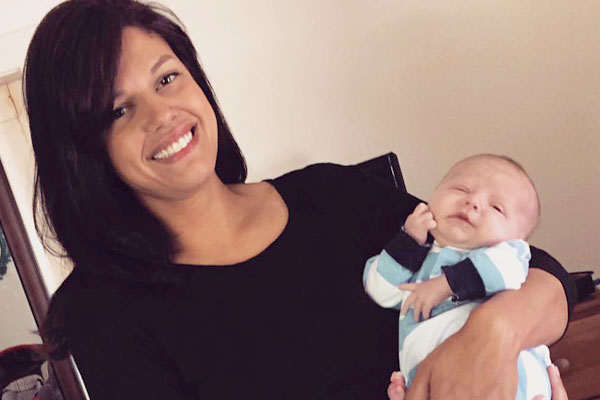 Photo of Emily holding a baby